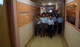 Orphans are studying through data on the wall of the corridor